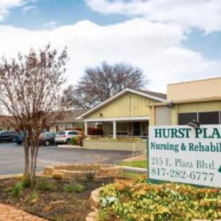 Exterior view of Hurst Plaza Nursing & Rehabilitation, showcasing the building and its surrounding landscape.