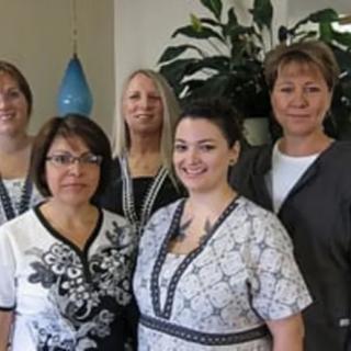 A group of women posing together indoors.