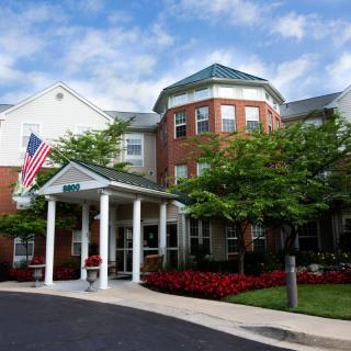 A residential building with a prominent entrance and landscaped surroundings.