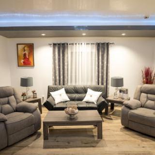 A cozy and modern living room featuring comfortable seating, elegant curtains, and stylish decor.