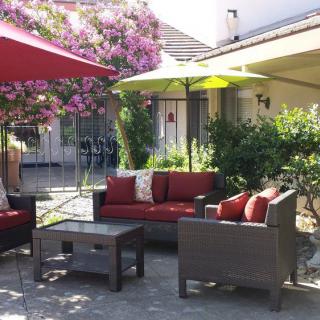 A cozy outdoor patio with comfortable seating and colorful umbrellas.