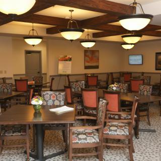A cozy dining room with wooden furniture and warm lighting.