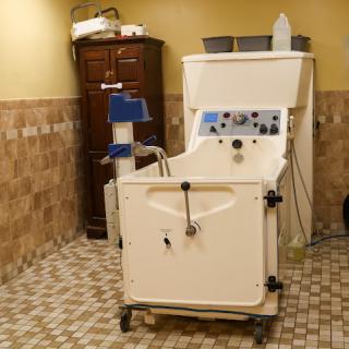 A hydrotherapy machine designed for therapeutic treatments, set up in a cozy treatment room.