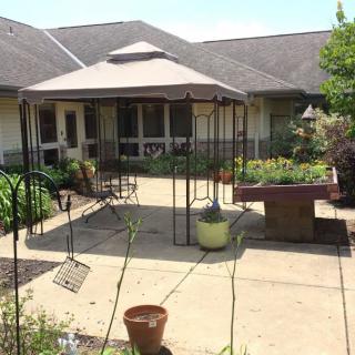 A tranquil courtyard with a gazebo and surrounding garden.