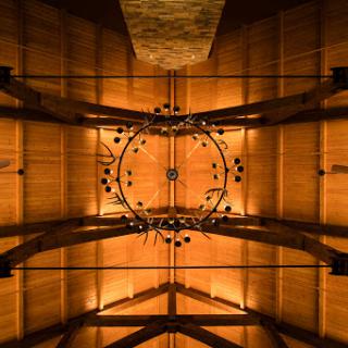 A stunning view of an intricately designed wooden ceiling, illuminated by warm lighting.
