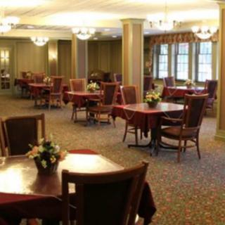 An elegant dining area with neatly arranged tables and comfortable seating.