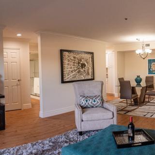 A stylishly decorated living and dining area with elegant furnishings and artwork on the walls.