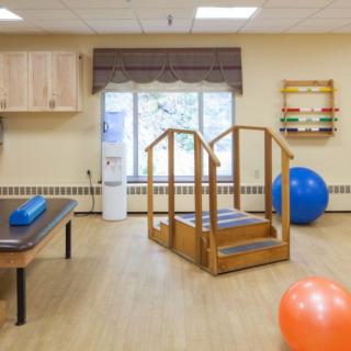 A physical therapy room equipped with various rehabilitation tools and exercise equipment.