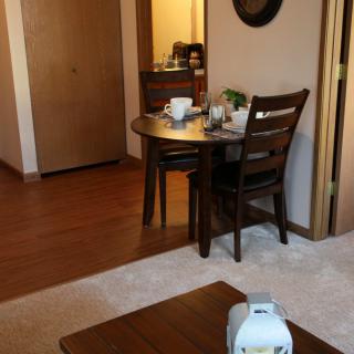 A cozy dining area with a wooden table and chairs in a home's interior.