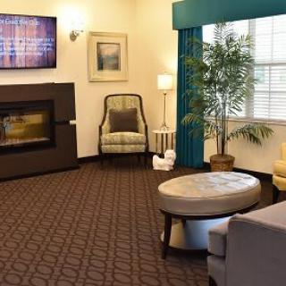 A cozy living room with a modern fireplace and comfortable seating.