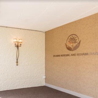 A sophisticated interior featuring a decorative wall sconce and branding.
