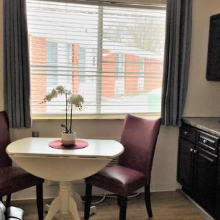 A cozy dining nook with a small table and chairs, featuring a lovely window view.