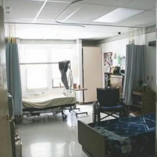 A hospital room with beds, medical equipment, and a wheelchair.