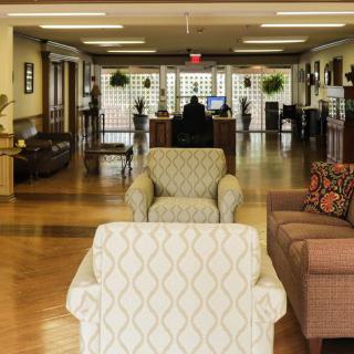 A spacious lobby area with comfortable seating and a reception desk.