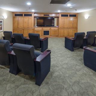 A well-designed home theater room with comfortable seating and a large screen.
