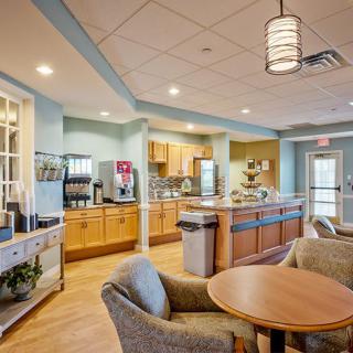 A modern kitchen and dining area with comfortable seating and appliances.