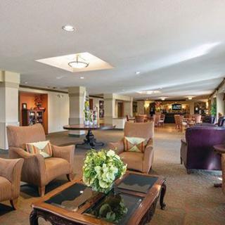 A spacious hotel lobby with comfortable seating and elegant decor.