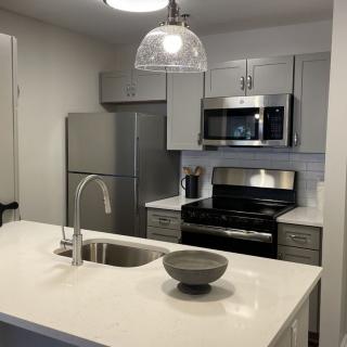 A modern kitchen featuring stainless steel appliances and a sleek countertop.
