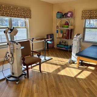A well-lit therapy room equipped for rehabilitation and physical therapy.