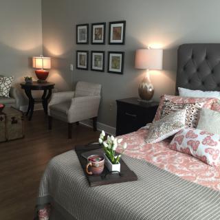 A cozy bedroom with stylish decor and comfortable furnishings.