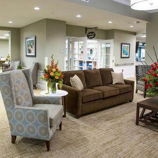 Modern lobby with comfortable seating and floral arrangements.