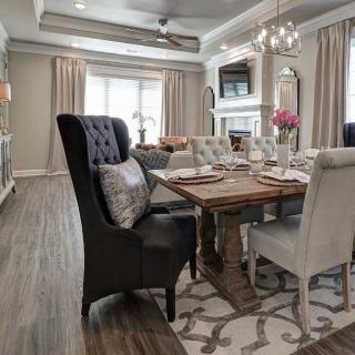 A stylish dining room with elegant furnishings and a modern chandelier.