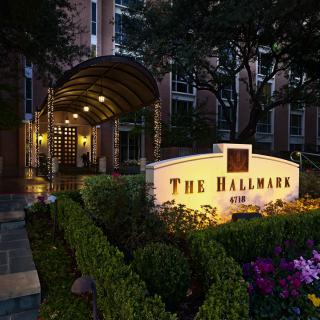 Elegant entrance of The Hallmark building illuminated at night.