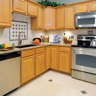 A modern kitchen with wooden cabinets and stainless steel appliances.