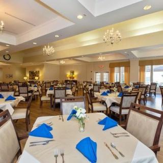Elegantly decorated dining room with tables set for guests.