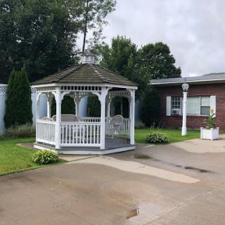 A charming gazebo surrounded by greenery, providing a perfect spot for relaxation.