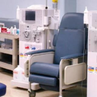 A dialysis treatment setup with a comfortable chair and medical equipment in a clinic.