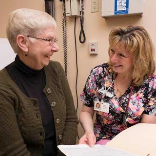 A nurse is consulting with a patient in a medical setting.
