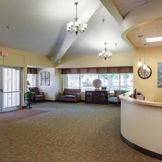 A well-lit lobby area with a reception desk and comfortable seating.