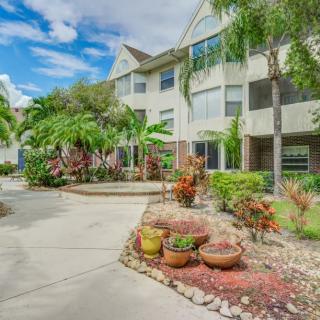 A well-landscaped apartment building with vibrant plants under a clear blue sky.