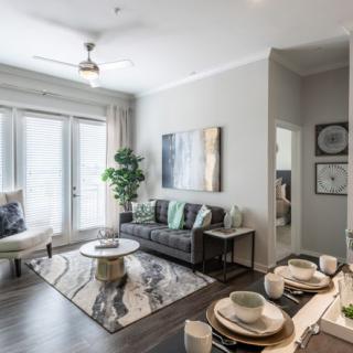 A modern living room with stylish decor, featuring a comfortable sofa, a coffee table, and bright natural lighting.