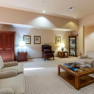 A cozy living room with comfortable seating and warm lighting.