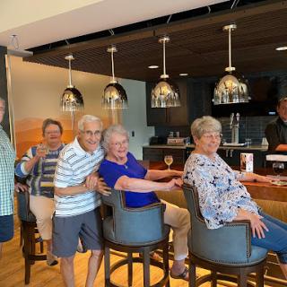 A cheerful gathering of friends enjoying time together at the bar.