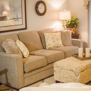 A cozy living room with a comfortable sofa, decorative pillows, and warm lighting.