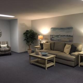 A cozy living room with a comfortable sofa, coffee table, and ambient lighting.