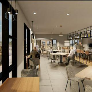 A modern restaurant interior featuring a spacious dining area with contemporary furniture and ample natural light.