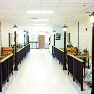 A brightly lit hallway with benches and decorative lighting.