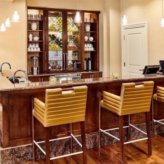 A modern bar setup with comfortable seating and elegant lighting.