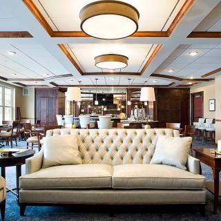 Elegant lounge area with comfortable seating and a sophisticated bar in the background.