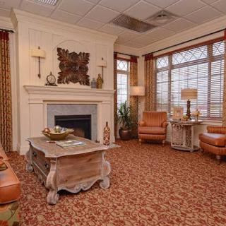 A cozy living room featuring warm tones, a stylish fireplace, and comfortable seating.