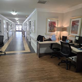 A modern office space featuring workstations along a spacious hallway.