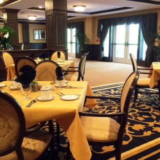 An elegant dining room with sophisticated table settings and luxurious decor.
