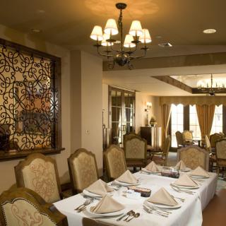 An elegantly designed restaurant dining room with a neatly set table.