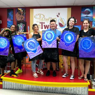 A vibrant art class where participants showcase their colorful paintings, celebrating creativity and collaboration.