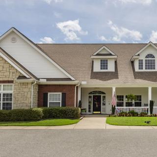 A suburban residential house with a well-kept lawn and driveway.