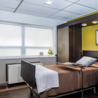 A well-organized hospital room with a neatly made bed and modern decor.